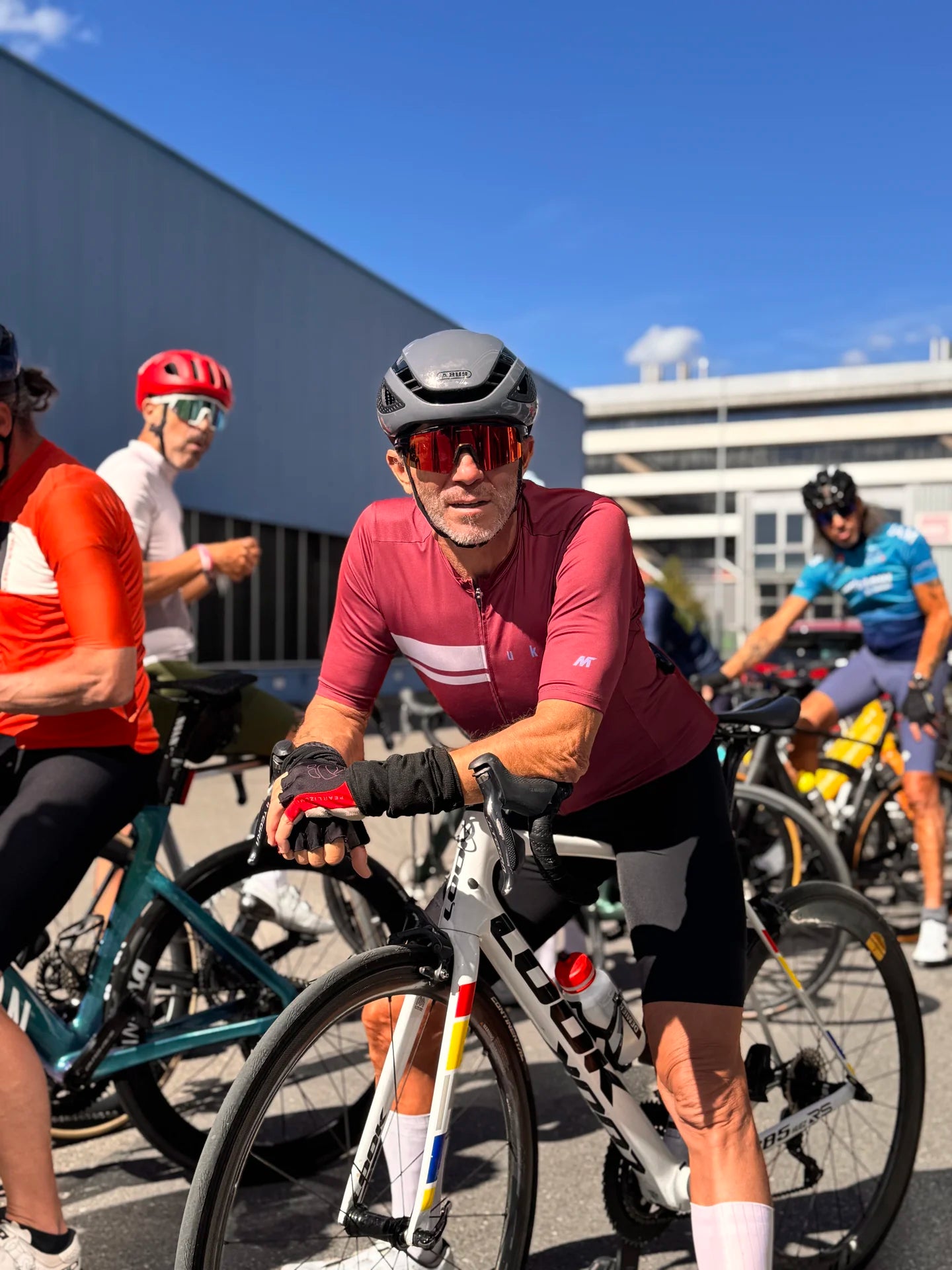 Cycliste souriant appuyé sur son vélo de route Look lors d'une session communauté Bcyclet